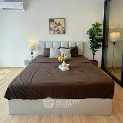 Modern bedroom with stylish decor, featuring a comfortable bed, elegant lighting, and a cozy ambiance.