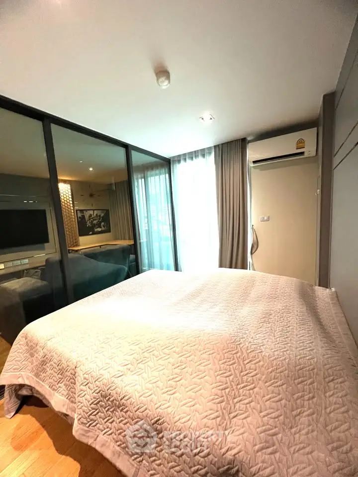 Modern bedroom with large windows and air conditioning in a stylish apartment.