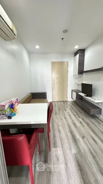 Modern living room with sleek furniture and stylish flooring in a contemporary apartment.