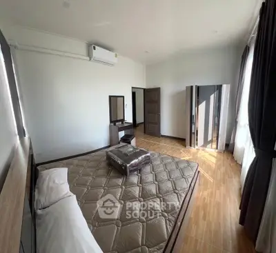 Spacious bedroom with modern furniture and natural light