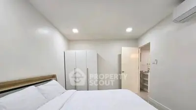Spacious bedroom with modern wardrobe and air conditioning