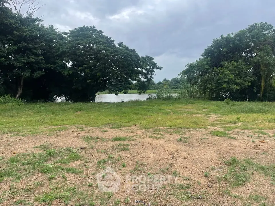 Scenic view of lush greenery and tranquil water body, perfect for serene real estate development.