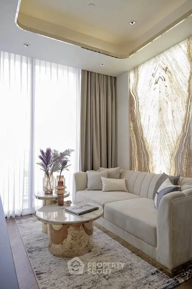 Luxurious living room with elegant sofa, marble accent wall, and floor-to-ceiling windows for natural light.