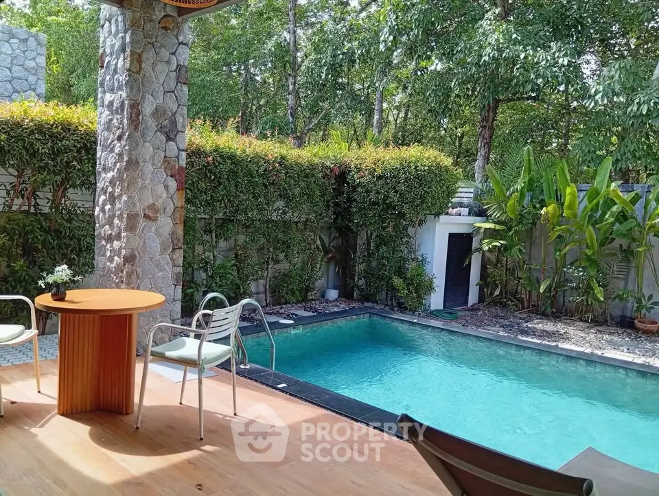 Charming backyard with a private pool and lush greenery, perfect for relaxation and outdoor entertainment.