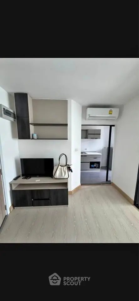 Modern living room with sleek furniture and open kitchen view