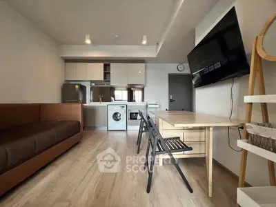 Modern open-plan living room with kitchen and washing machine