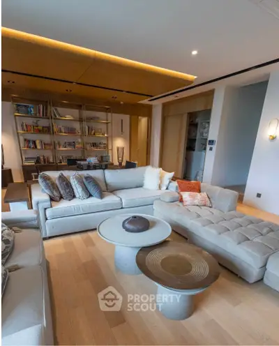 Luxurious living room with modern furniture and stylish decor, featuring a cozy sectional sofa and elegant lighting.