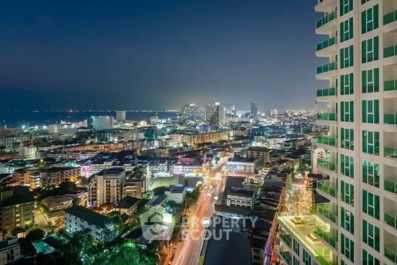Stunning cityscape view from high-rise building at night, showcasing vibrant urban lights and skyline.