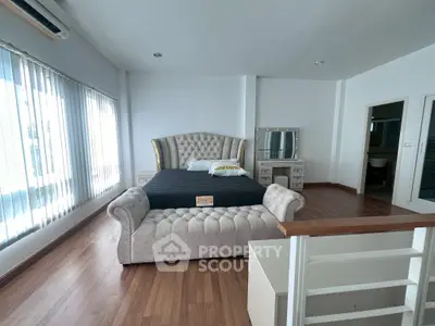 Luxurious bedroom with elegant furniture and natural light in modern real estate property.