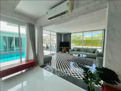 Luxurious living room with pool view and modern decor