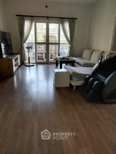 Spacious living room with modern decor and large windows for natural light.