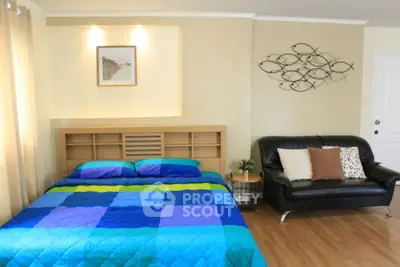 Spacious bedroom with modern decor and cozy seating area