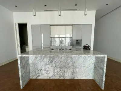 Luxurious modern kitchen with marble island and sleek cabinetry