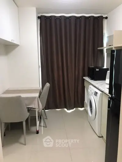 Modern dining area with sleek furniture and elegant curtains