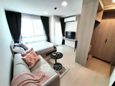 Modern studio apartment with cozy living area and natural light