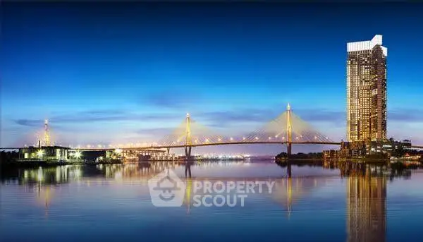 Stunning riverside view with illuminated bridge and modern high-rise building at dusk.