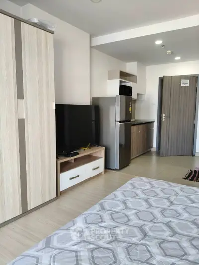 Modern studio apartment with sleek kitchen and cozy living area