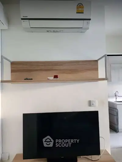 Modern interior with air conditioning and TV setup in a stylish living space.