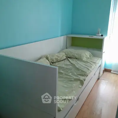 Cozy bedroom with modern single bed and bright blue walls