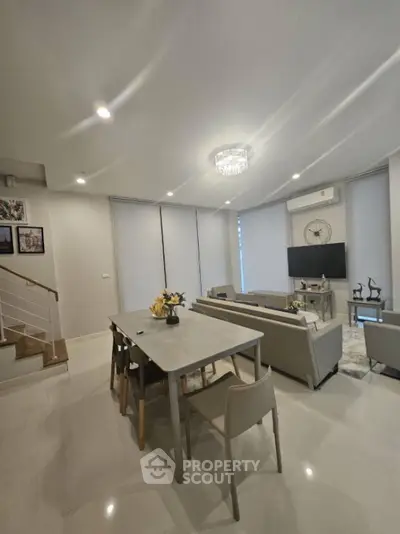 Modern living room with elegant dining area and stylish decor