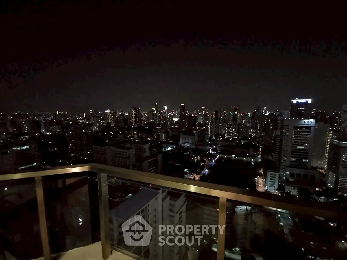 Stunning city skyline view from a high-rise balcony at night, perfect for urban living enthusiasts.
