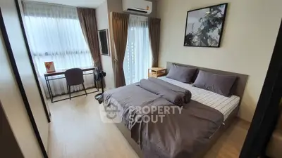 Modern bedroom with stylish decor, featuring a cozy bed, study desk, and large windows for natural light.