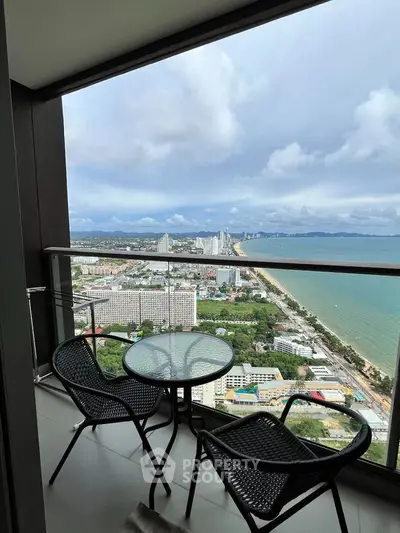 Stunning high-rise balcony with breathtaking ocean and city views, perfect for relaxation and enjoying the skyline.