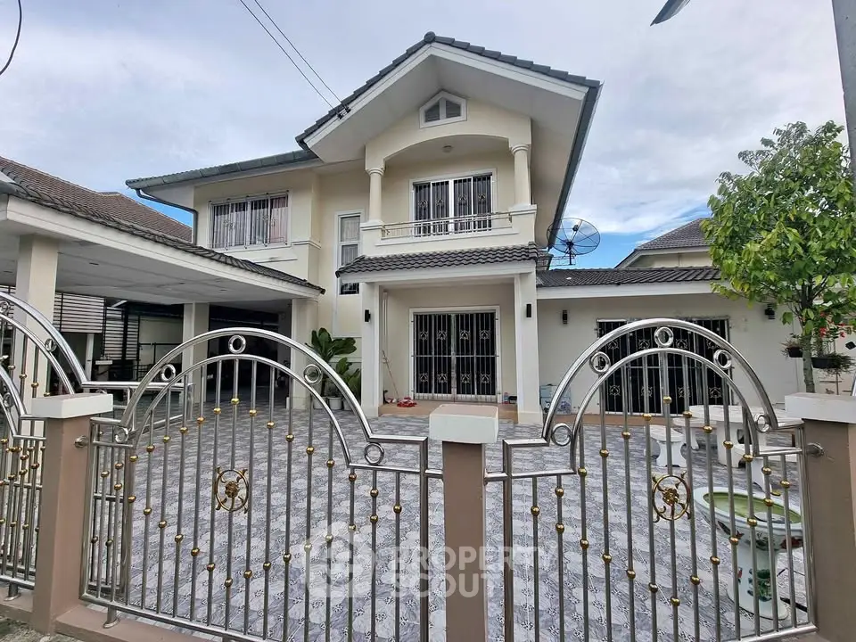 Charming two-story house with gated entrance and spacious driveway