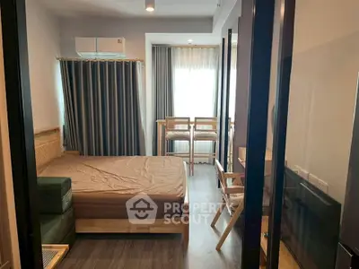 Cozy bedroom with modern furnishings and natural light, perfect for urban living.