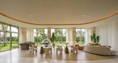 Luxurious living room with floor-to-ceiling windows and garden view