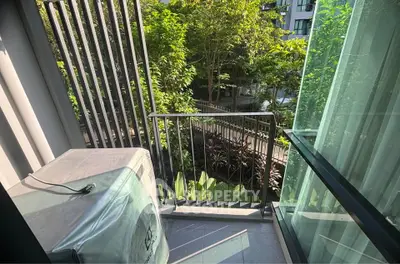 Charming balcony with lush garden view in modern apartment complex