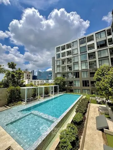 Luxurious urban apartment complex with stunning outdoor pool and city views.