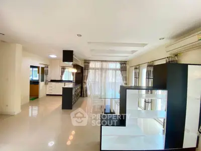 Spacious modern living room with open kitchen and large windows