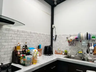 Modern kitchen with sleek countertops and organized dish rack
