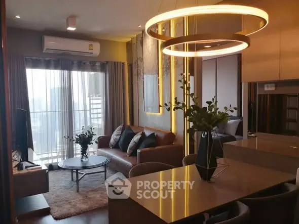 Modern living room with stylish decor and city view from balcony.