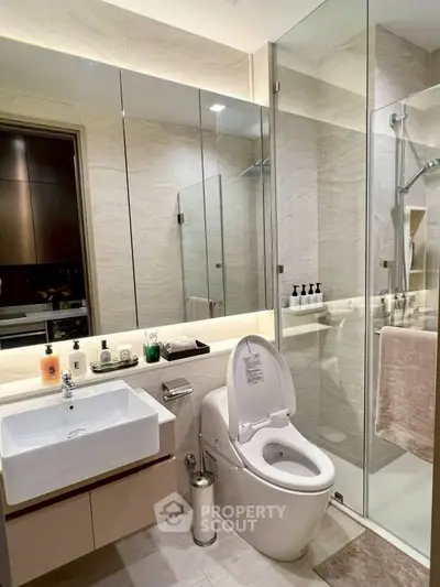 Modern bathroom with sleek fixtures and glass shower enclosure