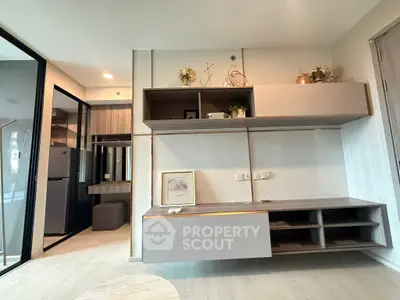 Modern living room with sleek built-in storage and open kitchen layout