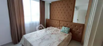 Cozy bedroom with elegant tufted headboard and large window for natural light.