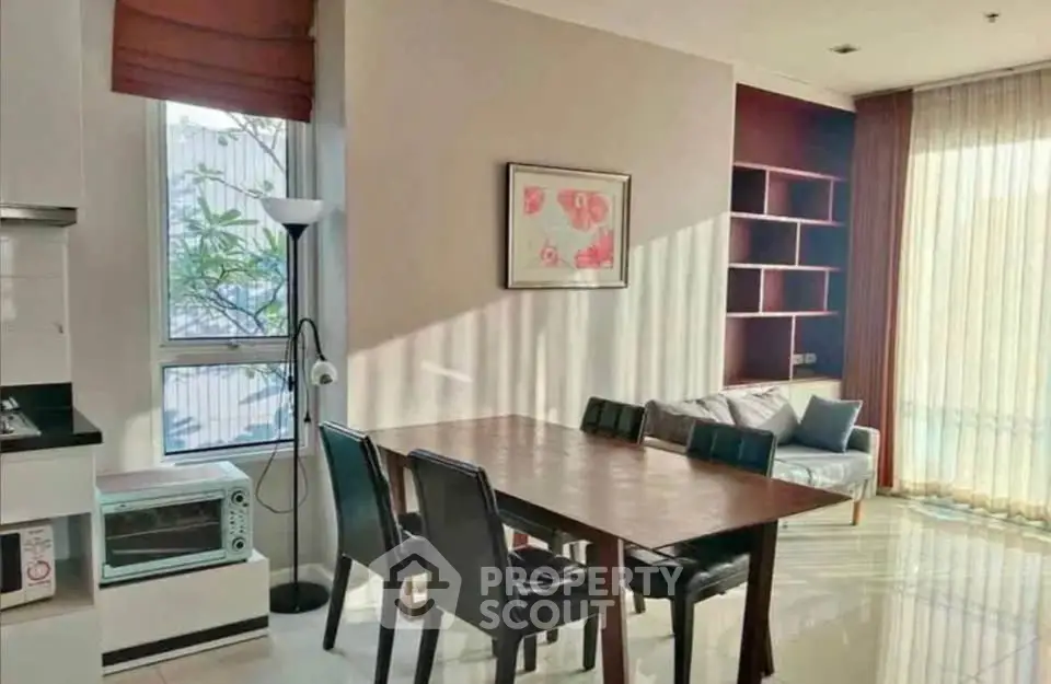Bright dining area with modern furniture and natural light in a stylish apartment.