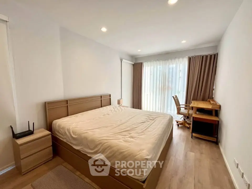 Spacious bedroom with modern furnishings and natural light