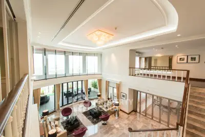 Luxurious two-story living room with elegant decor and large windows offering stunning views.
