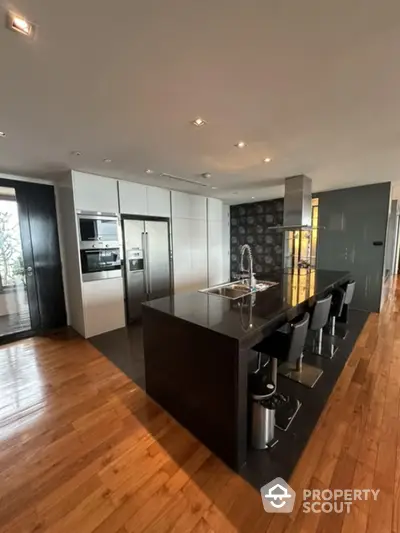 Luxurious modern kitchen with sleek black island and high-end appliances