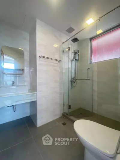 Modern bathroom with glass shower and sleek fixtures