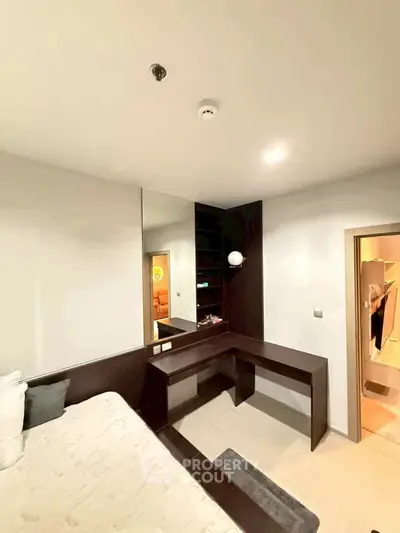 Modern bedroom with sleek built-in desk and cozy lighting