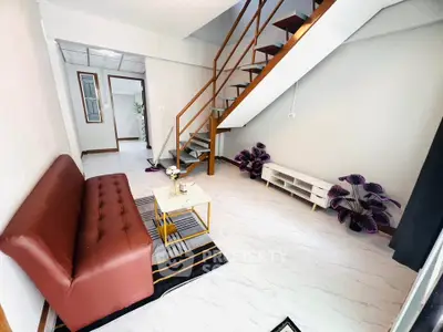 Modern living room with stylish staircase and cozy seating area