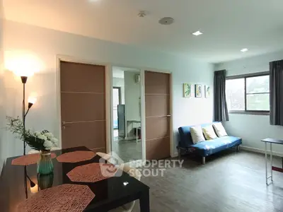 Spacious living room with modern decor and ample natural light