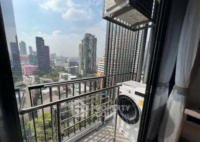 Chic urban balcony with city view and laundry area