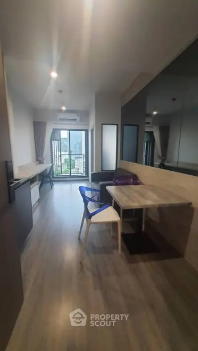 Modern apartment interior with stylish dining area and large window view