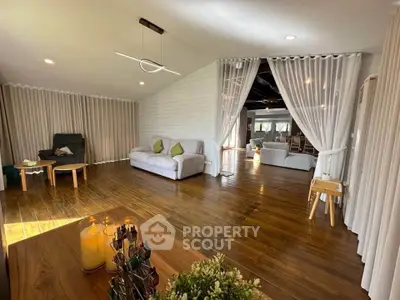 Spacious living room with elegant wooden flooring and modern decor