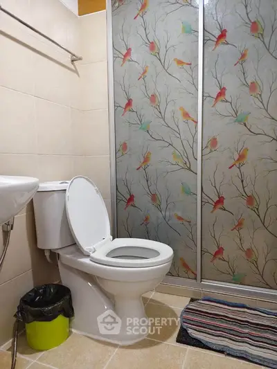 Charming bathroom with bird-themed shower doors and modern fixtures.